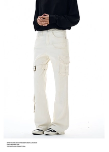Detailed view of off-white cargo jeans with metal buckle strap and large utility pockets