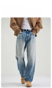 Close-up of straight fit blue denim jeans with stone wash texture and black leather belt