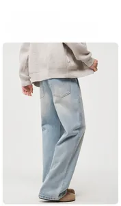 Rear view of light blue straight denim jeans showing high quality washed texture