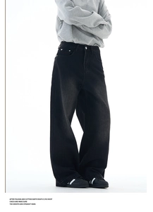 Detail showing vintage washed black wide-leg denim texture and loose fit tailoring