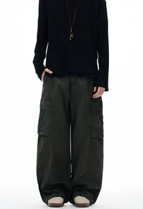 Detail of loose-fit cargo pants in olive green with multi-pocket design for men