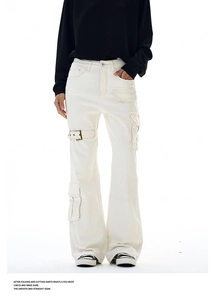Detailed view of white flared cargo pants with decorative straps and pockets
