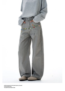 Detail of grey vintage wide leg jeans with floral embroidery on the hip and thigh area