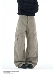 Detail view of khaki multi-pocket cargo pants with wide-leg cut and durable cotton fabric