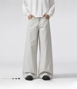 Detail showing loose straight fit of light grey cotton trousers for cleanfit look