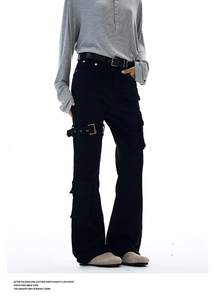 Detail of black cargo pants with strap pockets and metal buckles in high-street style
