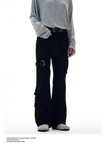 Detail of black cargo pants featuring metal buckle straps and utility pockets on the leg