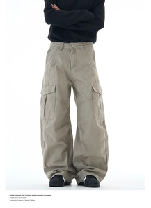 Macro shot of smooth seams and large flap pockets on greyish green wide-leg cargo pants