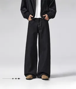 Detail showing the loose straight fit of these black vintage style wide-leg denim jeans