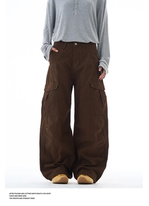 Detail of dark brown multi-pocket cargo pants with wide-leg cut and retro streetwear style