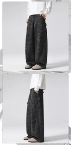 Detail view of baggy camouflage cargo pants with large side pockets and relaxed fit