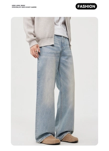 Detail of light blue washed straight denim jeans styled with a casual minimalist outfit