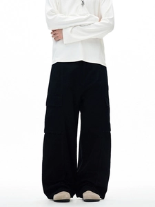 Men's loose black cargo pants with large side pockets and relaxed straight fit styling