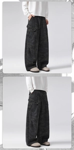 Detail view of oversized vintage camo cargo pants with multiple flap pockets and loose fit