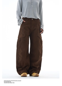 Detailed view of brown multi-pocket cargo pants with durable cotton twill texture