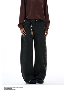 Detail view of American vintage patchwork trousers with a retro metal keychain accessory