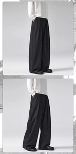 Close-up of wide-leg trousers with vertical stripes and high-quality drape texture