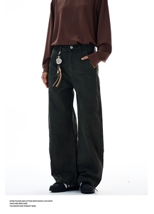 Detail of dark canvas curved casual pants featuring stitch lines and silver key ring
