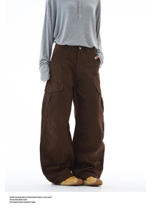 Detailed view of dark brown cotton canvas cargo pants with large side flap pockets