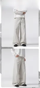 Detail view of men's wide-leg twill cotton trousers with side pocket and clean fit design