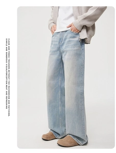 Detail of light blue straight wide-leg denim jeans with washed vintage texture