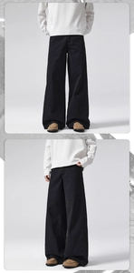 Macro view of men's black high-waisted wide-leg twill cotton trousers with straight cut