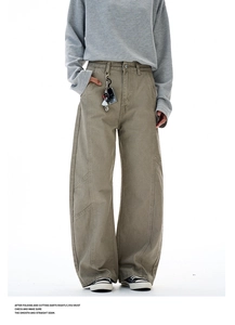Detailed view of panelled stitching on olive canvas wide-leg trousers for men and women