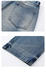 Detail of stone washed blue denim jeans showing rear pockets and hem stitching quality