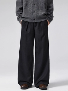 Women's high waist wide leg black wool trousers with pleated front details and loose fit