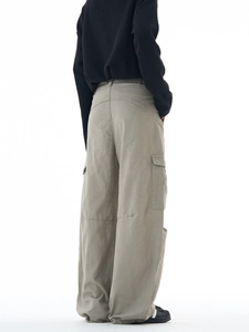 Mens high street loose fit grey multi-pocket cargo pants shown in a side profile view