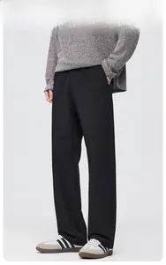 Detailed side view of black wide-leg trousers with elegant drape and pleat design