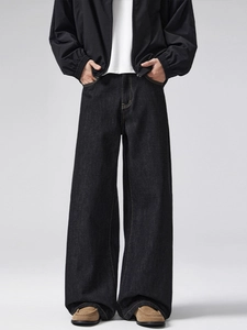 Vintage men's black wide-leg denim jeans with relaxed fit and yellow contrast stitching