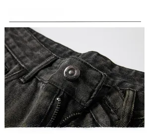 Gros plan détaillé sur le bouton en métal vintage et la texture denim du jean baggy gris