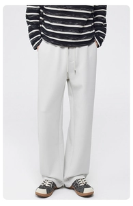 Front view of light grey wide-leg trousers with elastic drawstring waist and heavy knit fabric
