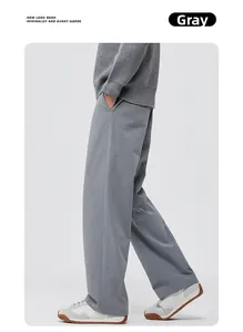 Detailed view of grey wide-leg trousers featuring premium drape fabric and side pocket design