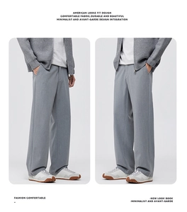 Detail view of men's grey wide-leg trousers in American loose fit and premium drape