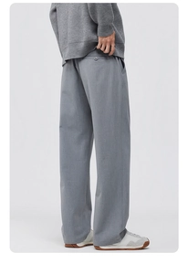 Detailed side-back view of men's grey wide-leg trousers featuring a subtle twill texture
