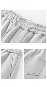 Detail of grey men's joggers showing elastic waistband with drawstring and fine fabric texture