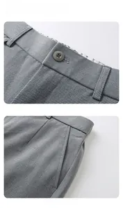 Detailed macro view of dark grey trousers showing twill fabric texture and button waist