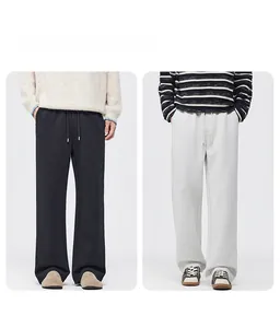 Men's wide-leg knit drawstring trousers in black and cream white fleece-lined fabric