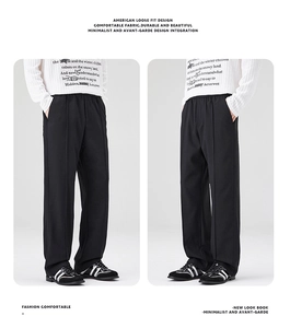 Détail du pantalon noir coupe large américaine avec drapé fluide et plis marqués