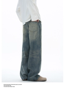 Close-up of vintage washed blue wide-leg jeans with retro faded texture and loose fit