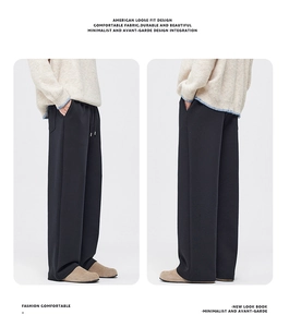 Detail view of American loose fit black wide-leg trousers with premium drape and thick fabric