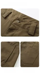 Detail view of khaki work pants showing reinforced metal button and twill fabric texture