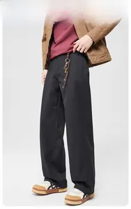Detail view of men's vintage black wide-leg trousers with premium twill texture and drape