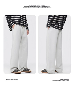 Detail of elastic waist and metal drawstring on men's beige straight leg casual pants