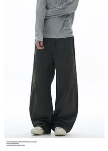 Detailed view of dark charcoal cargo pants with horizontal knee seam and vintage wash