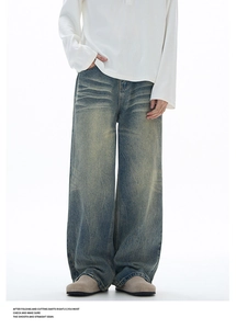 Detailed texture of heavy cotton denim with vintage yellow wash and distressed finish