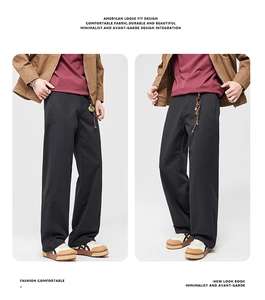 Detail of American loose fit black trousers with a smooth drape and durable fabric texture