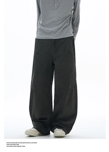 Macro detail of charcoal grey cargo pants showing stitched seam design and fabric texture